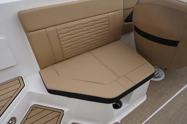 Slide: The Image of 2024 Sea Ray SPX 230 boat interior with tan seating and modern design. - 32