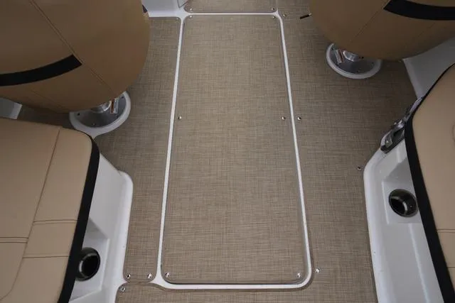 Slide: The Image of 2024 Sea Ray SPX 230 boat interior with beige seating and carpeted flooring. - 34