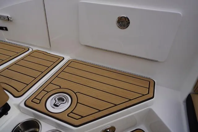 Slide: The Image of 2024 Sea Ray SPX 230 boat deck with wood finish and storage compartment. - 38