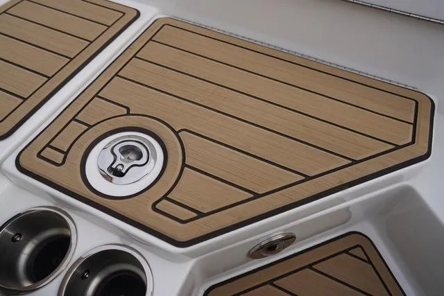 Slide: The Image of 2024 Sea Ray SPX 230 boat deck with wood finish and metal fixtures. - 40