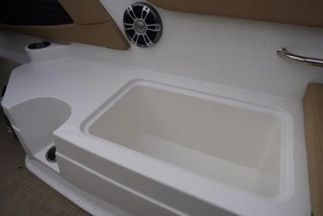 Slide: The Image of 2024 Sea Ray SPX 230 boat interior with storage compartment and speaker. - 43