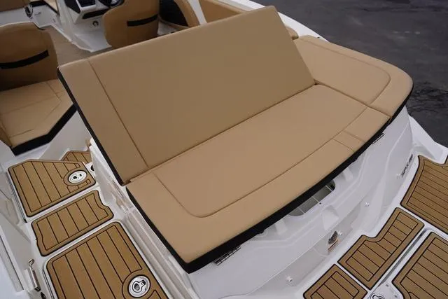 Slide: The Image of 2024 Sea Ray SPX 230 boat interior with tan seating and teak-style flooring. - 45