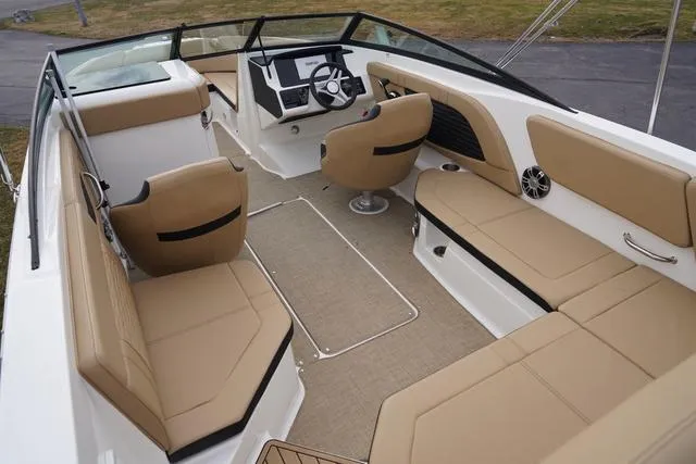 Slide: The Image of 2024 Sea Ray SPX 230 boat interior with tan seating and modern dashboard design. - 46