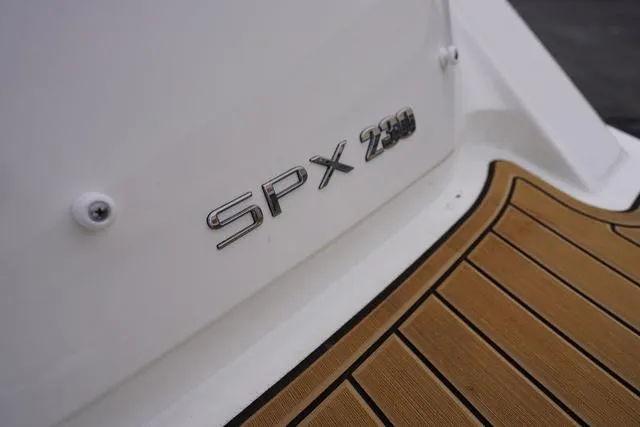 Slide: The Image of 2024 Sea Ray SPX 230 boat logo on white hull with teak deck. - 47