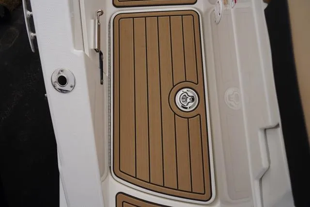 Slide: The Image of 2024 Sea Ray SPX 230 boat deck with wood finish and sleek design. - 48