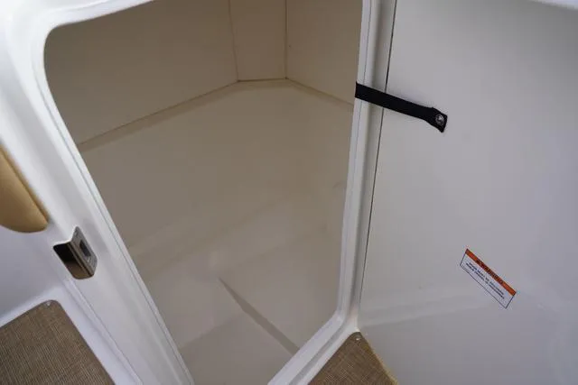 Slide: The Image of 2024 Sea Ray SPX 230 storage compartment with open door, showcasing interior space. - 6