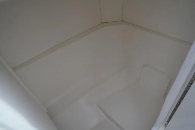 Slide: The Image of Interior storage compartment of 2024 Sea Ray SPX 230 boat, featuring clean white design. - 7