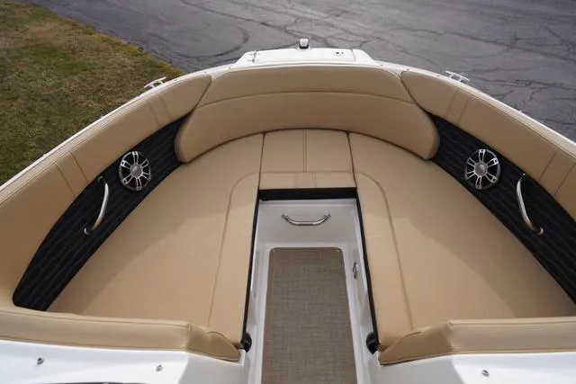 Slide: The Image of 2024 Sea Ray SPX 230 boat interior with tan seating and modern design. - 8