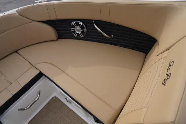 Slide: The Image of 2024 Sea Ray SPX 230 boat interior with tan leather seating and speaker detail. - 9
