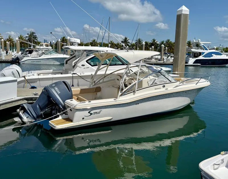 Slide: The Image of 2016 Scout 245 Dorado boat docked in a marina under a clear blue sky. - 1