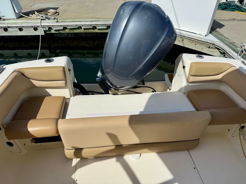 Slide: The Image of Control panel of a 2016 Scout 245 Dorado boat with steering wheel and navigation equipment. - 6