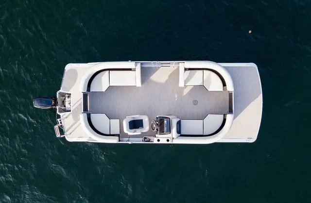 Slide: The Image of 2024 Harris Breeze 210 CW pontoon boat, aerial view over water. - 8