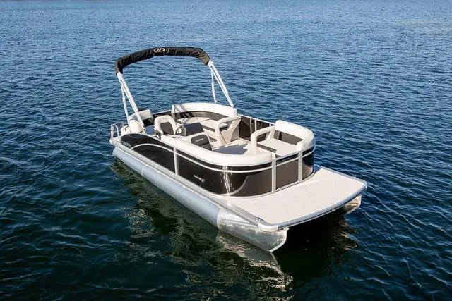 Slide: The Image of 2024 Harris Breeze 210 CW pontoon boat on calm blue water. - 9