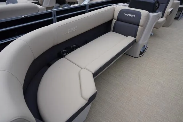 Slide: The Image of 2024 Harris Cruiser 230 CWDH boat interior with beige seating and cup holders. - 12