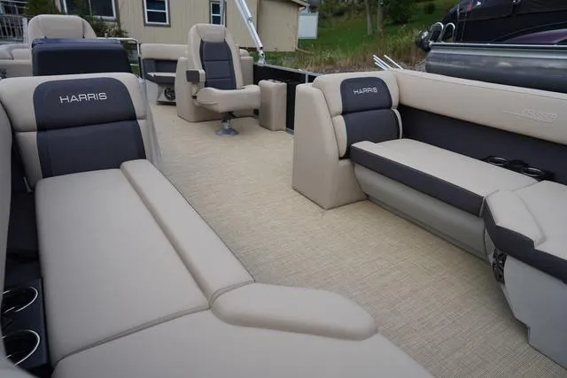 Slide: The Image of 2024 Harris Cruiser 230 CWDH boat interior with beige and black seating. - 14