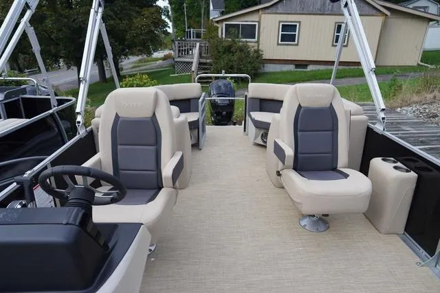 Slide: The Image of 2024 Harris Cruiser 230 CWDH pontoon boat interior with beige and gray seating. - 17