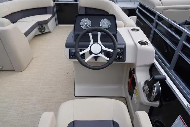 Slide: The Image of 2024 Harris Cruiser 230 CWDH boat interior with steering wheel and seating. - 19
