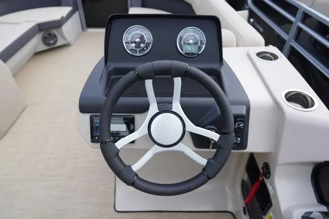 Slide: The Image of 2024 Harris Cruiser 230 CWDH steering wheel and dashboard, featuring modern gauges and controls. - 20