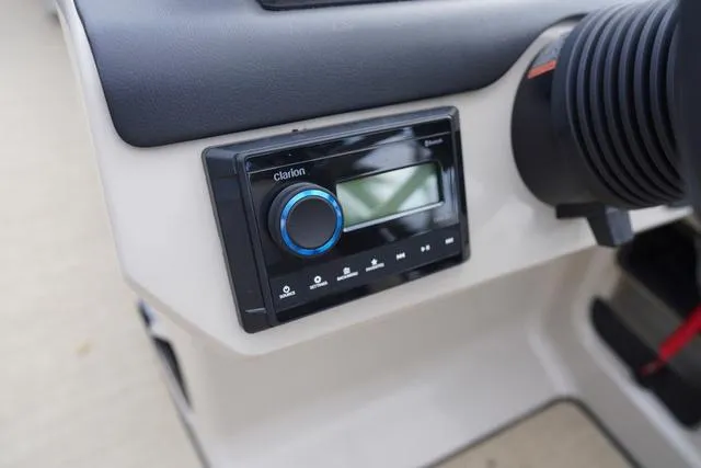 Slide: The Image of 2024 Harris Cruiser 230 CWDH dashboard with Clarion stereo system. - 22