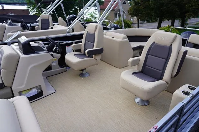 Slide: The Image of 2024 Harris Cruiser 230 CWDH boat interior with beige seating and modern helm. - 24