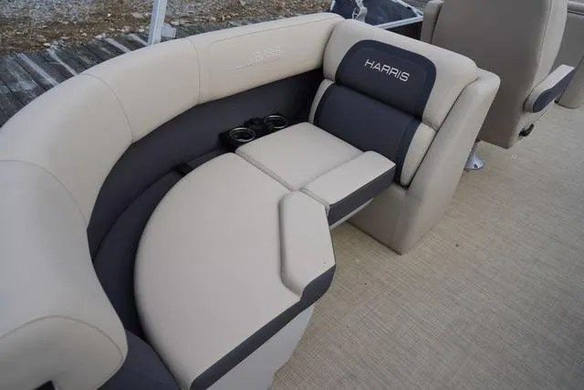 Slide: The Image of 2024 Harris Cruiser 230 CWDH boat seating with cup holders, beige and gray upholstery. - 28
