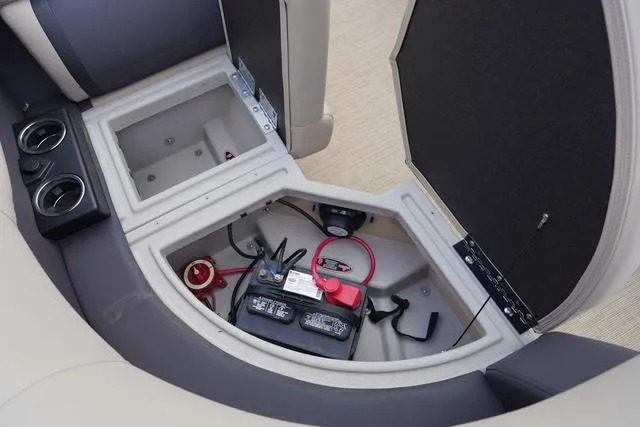 Slide: The Image of 2024 Harris Cruiser 230 CWDH boat battery compartment with storage and cup holders. - 32