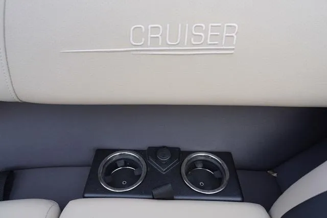 Slide: The Image of 2024 Harris Cruiser 230 CWDH boat interior with cup holders and embossed logo. - 33