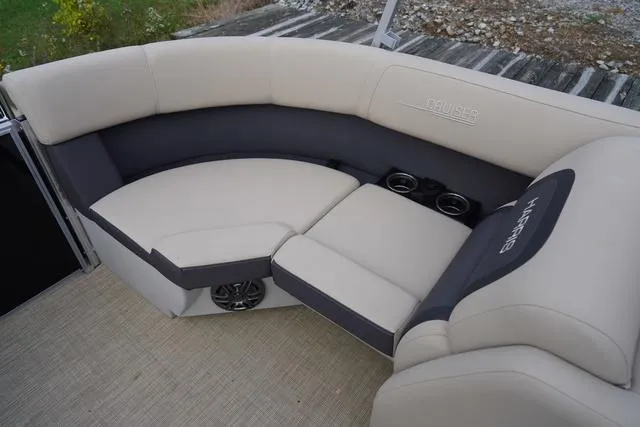 Slide: The Image of 2024 Harris Cruiser 230 CWDH boat interior with beige seating and cup holders. - 36