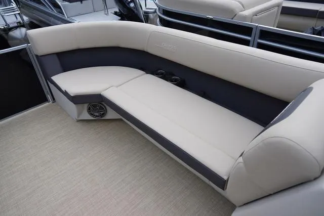 Slide: The Image of 2024 Harris Cruiser 230 CWDH boat interior with beige seating and cup holders. - 37