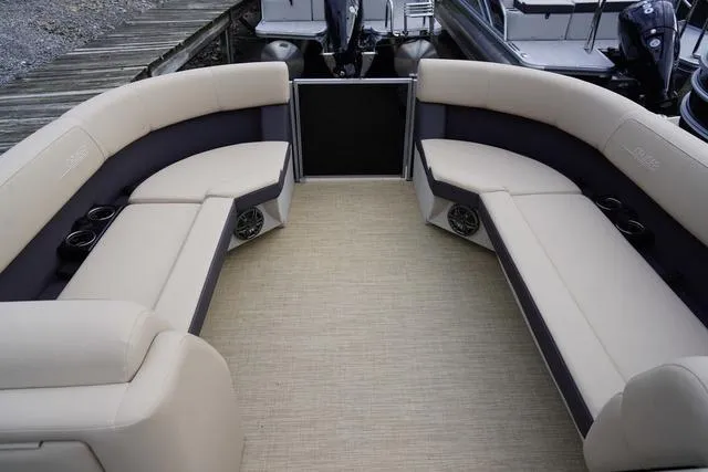 Slide: The Image of 2024 Harris Cruiser 230 CWDH pontoon boat interior with beige seating and cup holders. - 38