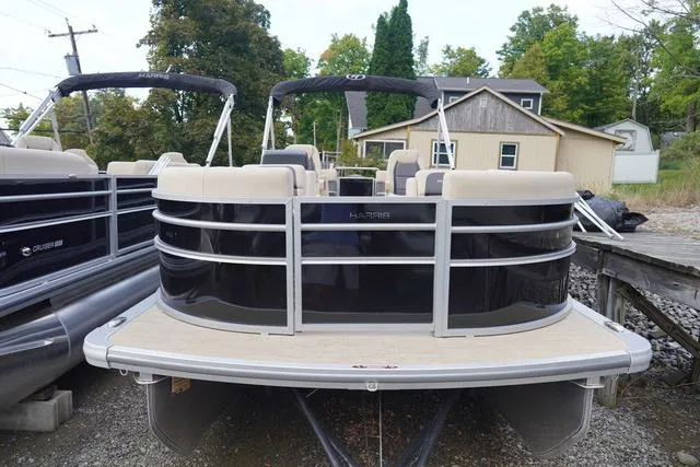 Slide: The Image of 2024 Harris Cruiser 230 CWDH pontoon boat docked, featuring sleek design and spacious seating. - 5