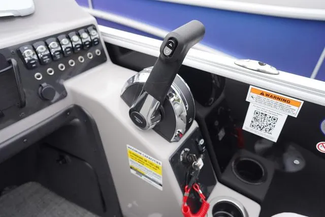 Slide: The Image of Control panel of 2025 Barletta Boats A22UC with throttle and warning labels. - 24