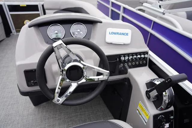 Slide: The Image of 2025 Barletta A22UC boat dashboard with steering wheel and control panel. - 28