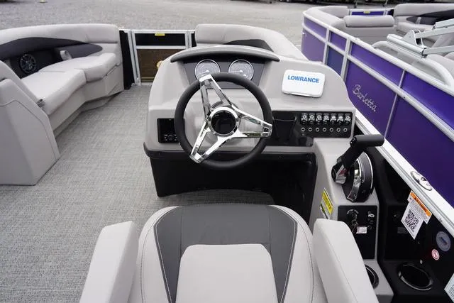 Slide: The Image of 2025 Barletta A22UC boat interior with steering wheel, control panel, and seating. - 29