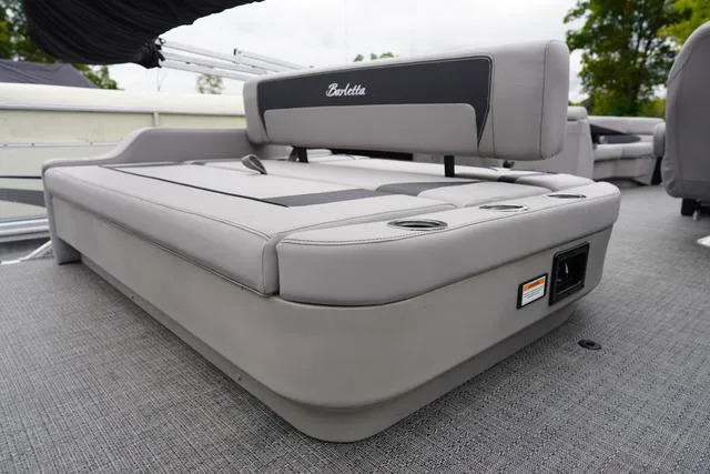 Slide: The Image of 2025 Barletta A22UC boat interior with gray cushioned seating and cup holders. - 3