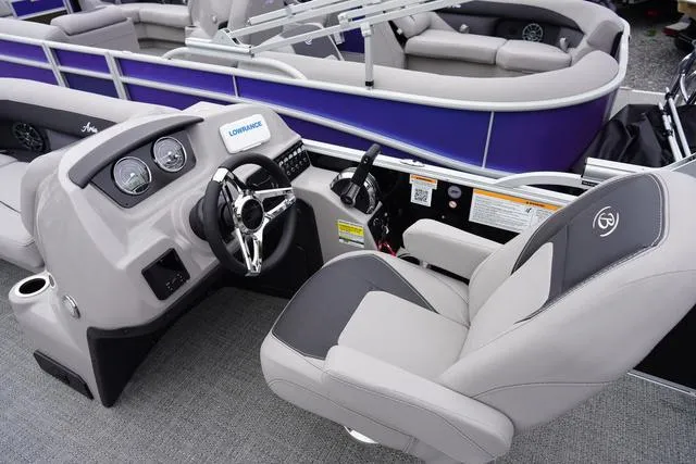 Slide: The Image of 2025 Barletta Boats A22UC pontoon boat cockpit with steering wheel and control panel. - 30