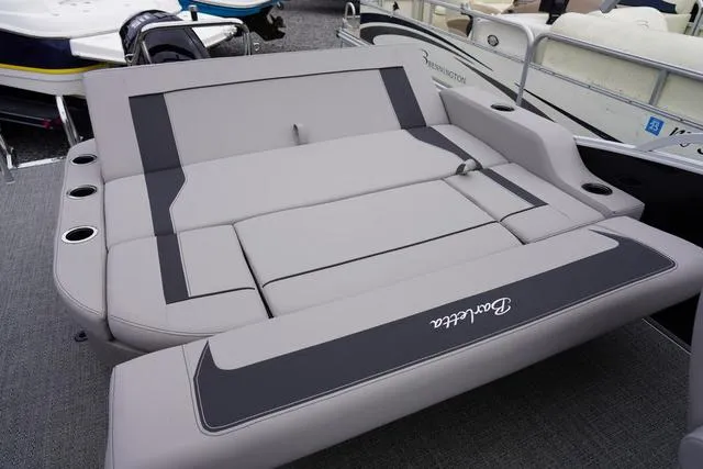 Slide: The Image of 2025 Barletta A22UC boat with gray seating and cup holders, showcasing luxury design. - 36