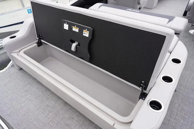 Slide: The Image of 2025 Barletta A22UC boat storage compartment with cup holders and cushioned seating. - 38