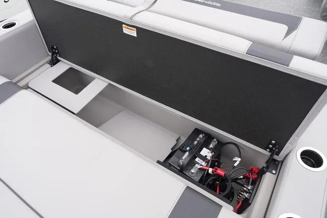 Slide: The Image of 2025 Barletta Boats A22UC storage compartment with battery and seating area. - 39