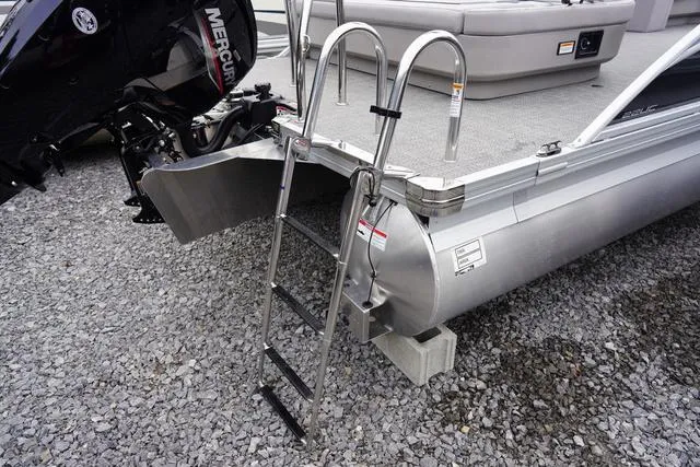 Slide: The Image of 2025 Barletta A22UC boat with ladder and Mercury engine on gravel surface. - 44