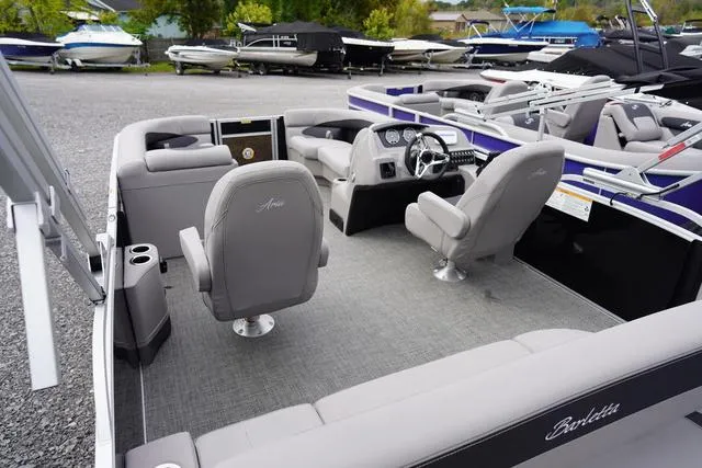 Slide: The Image of 2025 Barletta A22UC boat interior with gray seating and modern dashboard. - 6