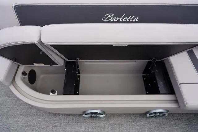 Slide: The Image of 2025 Barletta A22UC boat storage compartment with open seat, showcasing spacious interior. - 9