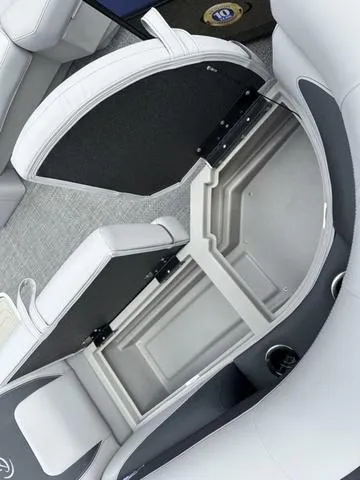 Slide: The Image of 2025 Barletta Boats A22UC interior storage compartment with open seat and cup holder. - 11