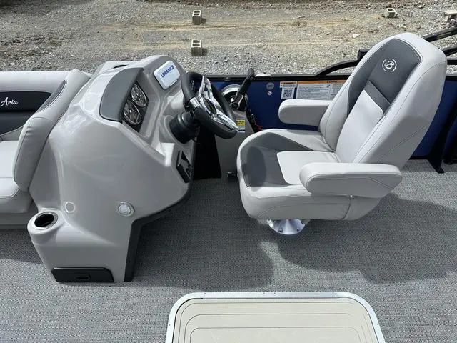 Slide: The Image of 2025 Barletta Boats A22UC helm with gray captain's chair and steering console. - 15