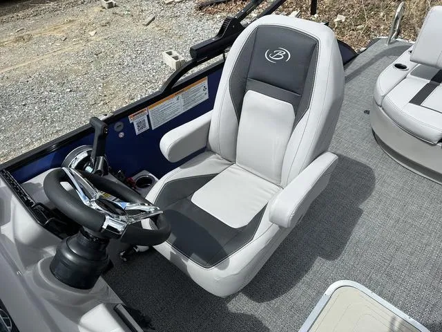 Slide: The Image of Captain's seat of 2025 Barletta Boats A22UC, featuring sleek design and modern controls. - 16