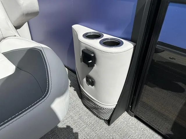 Slide: The Image of 2025 Barletta Boats A22UC interior with cup holders and charging ports. - 25