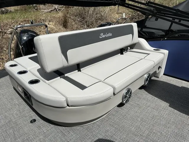 Slide: The Image of 2025 Barletta A22UC boat with sleek seating and cup holders on deck. - 30