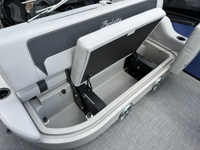 Slide: The Image of 2025 Barletta A22UC boat seat storage compartment with open lid, showcasing spacious interior. - 32