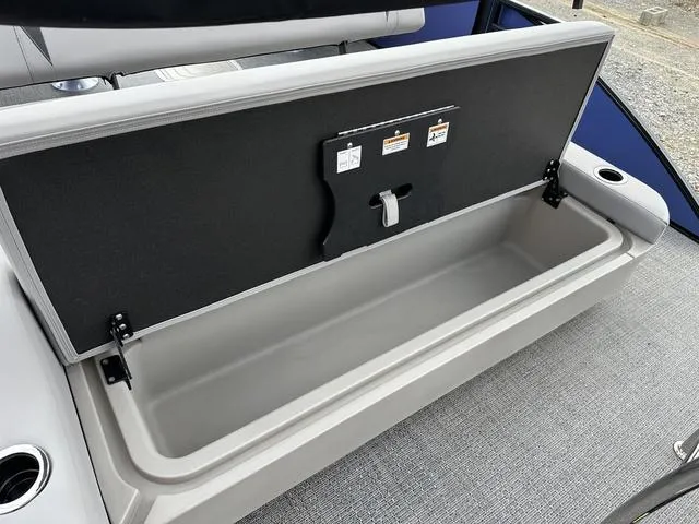 Slide: The Image of Open storage compartment on 2025 Barletta Boats A22UC, featuring spacious interior and secure latch. - 35