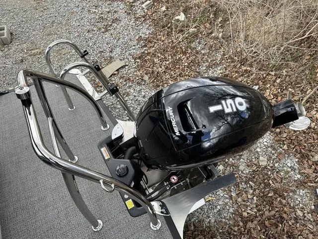 Slide: The Image of 2025 Barletta A22UC boat with Mercury 150 outboard motor on gravel surface. - 36